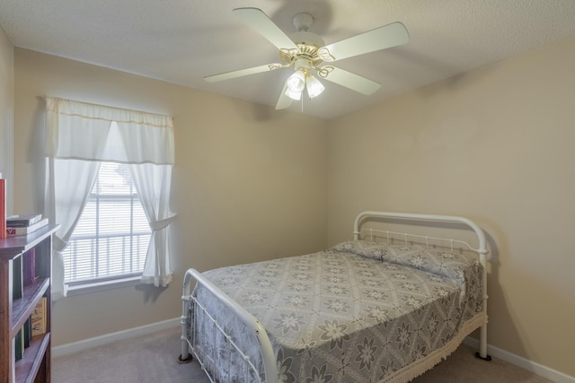 bedroom featuring ceiling fan and light carpet