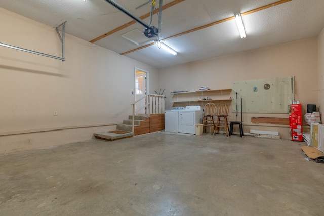 garage featuring a garage door opener and independent washer and dryer