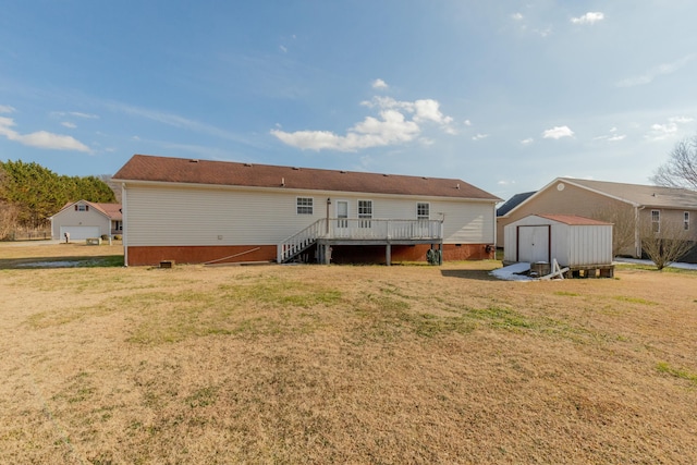 back of property featuring a lawn, a deck, and a storage shed