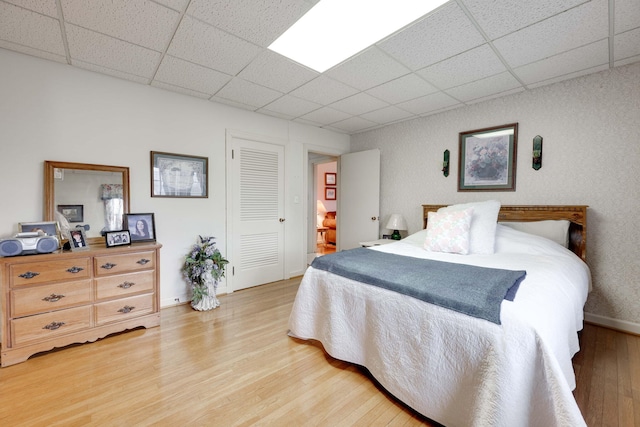 bedroom with hardwood / wood-style floors and a closet