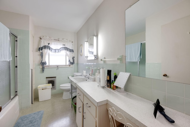 full bathroom featuring tasteful backsplash, combined bath / shower with glass door, toilet, vanity, and tile walls