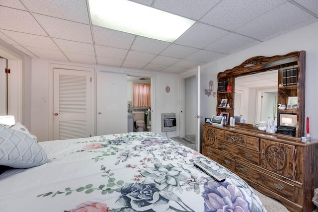 bedroom featuring heating unit and a closet