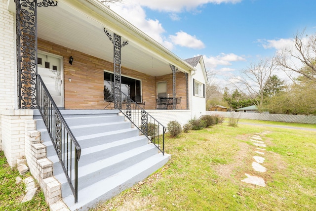 exterior space with a porch and a yard