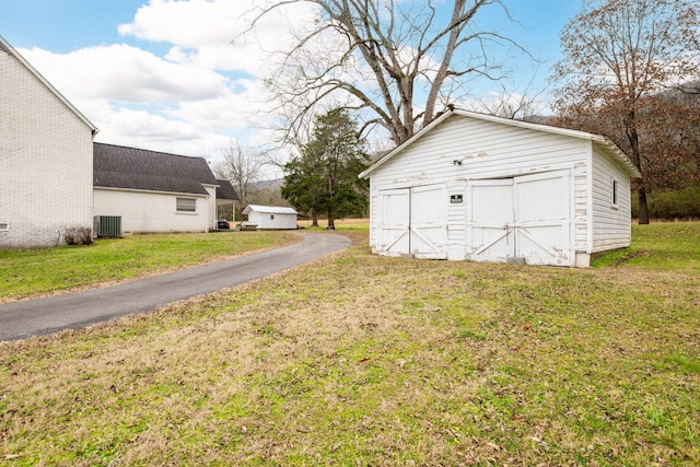 garage with a yard and central AC