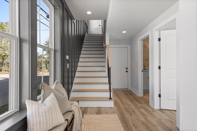 stairway with hardwood / wood-style flooring