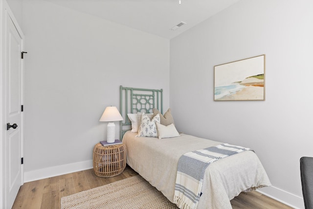 bedroom with hardwood / wood-style flooring