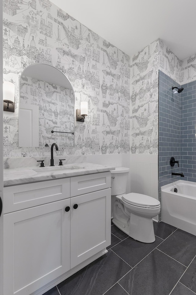 full bathroom featuring tile patterned floors, toilet, vanity, and tiled shower / bath