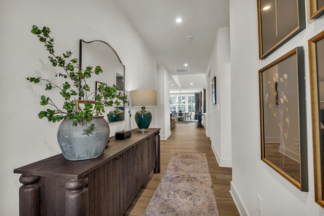 hallway with light hardwood / wood-style flooring