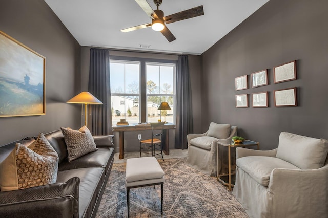 interior space with ceiling fan and carpet floors