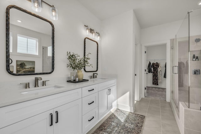 bathroom featuring tile patterned flooring, vanity, and walk in shower