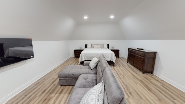 bedroom with lofted ceiling and light wood-type flooring