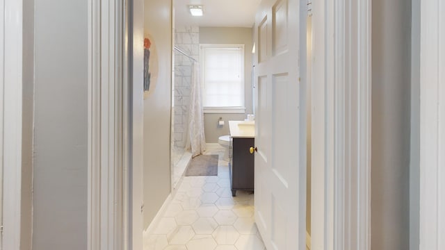 bathroom featuring walk in shower, tile patterned flooring, vanity, and toilet