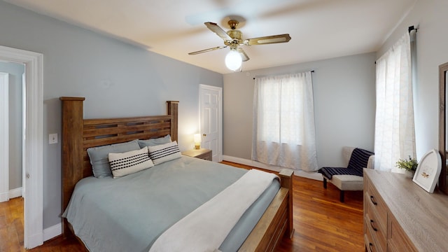 bedroom with ceiling fan and dark wood-type flooring