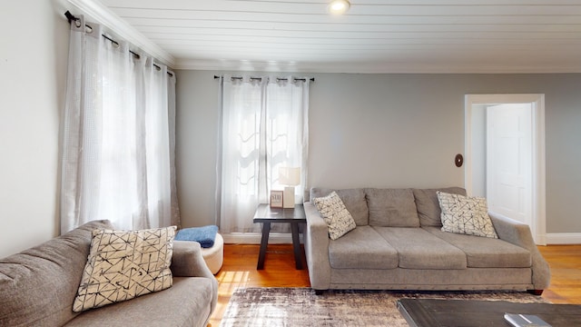 living room featuring crown molding, hardwood / wood-style floors, and wooden ceiling