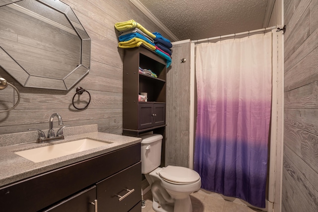 bathroom featuring vanity, a textured ceiling, crown molding, and wood walls