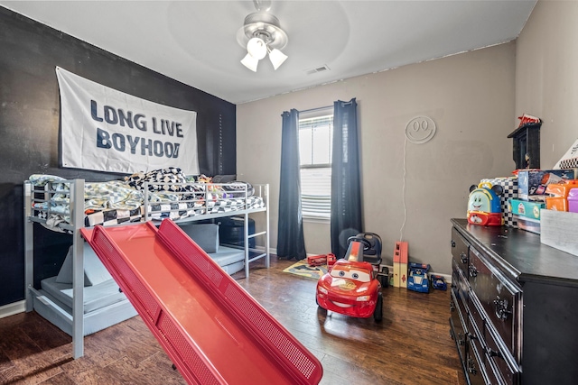 game room with ceiling fan, wood finished floors, and visible vents