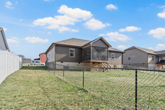 back of property featuring a sunroom, a fenced backyard, and a lawn