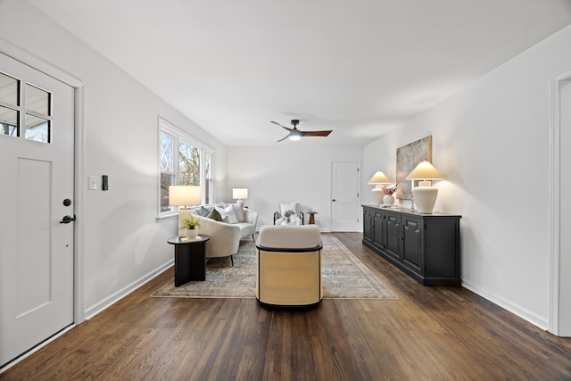 living room featuring ceiling fan and dark hardwood / wood-style flooring