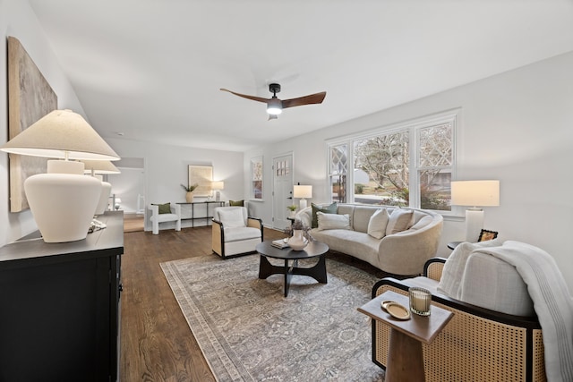 living room with ceiling fan and dark hardwood / wood-style floors