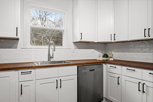 kitchen featuring dishwasher, white cabinetry, sink, and wooden counters