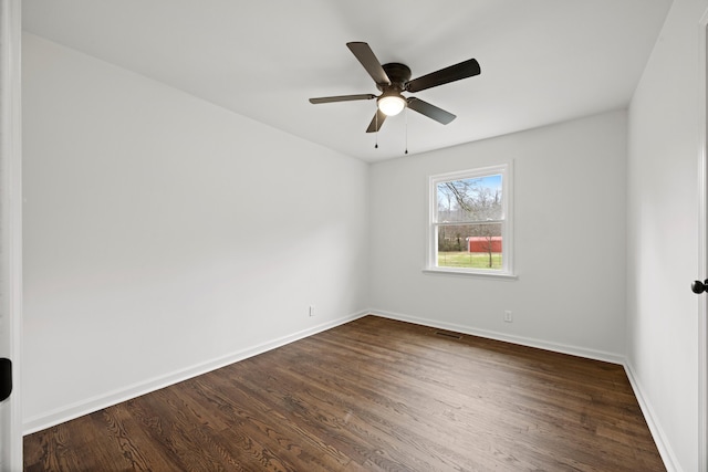 spare room featuring ceiling fan and dark hardwood / wood-style flooring