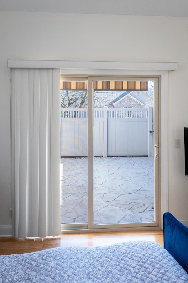 entryway with a wealth of natural light and hardwood / wood-style flooring