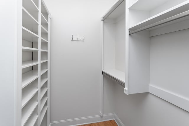 walk in closet featuring hardwood / wood-style flooring