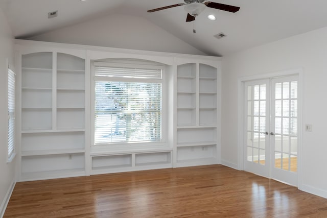 interior space with hardwood / wood-style floors, vaulted ceiling, ceiling fan, french doors, and built in shelves