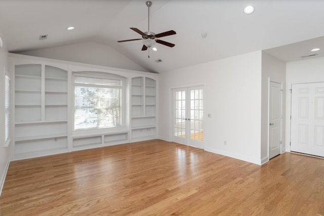 unfurnished living room with french doors, plenty of natural light, and built in shelves