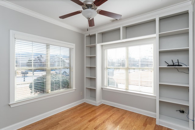 spare room featuring ceiling fan, light hardwood / wood-style floors, and crown molding