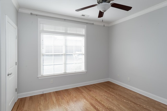 empty room with hardwood / wood-style flooring, ceiling fan, and ornamental molding