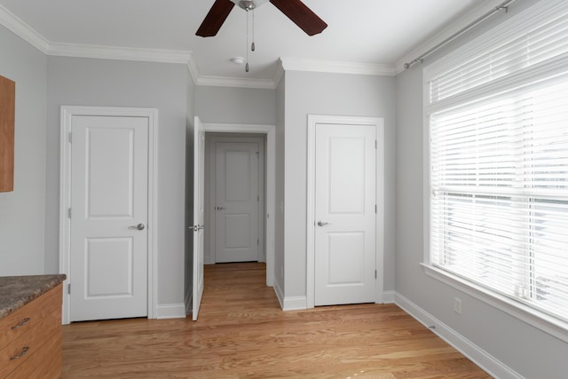 unfurnished bedroom featuring ceiling fan, light hardwood / wood-style floors, and crown molding