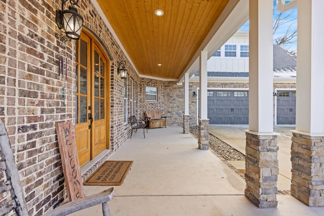 view of patio with a porch and a garage