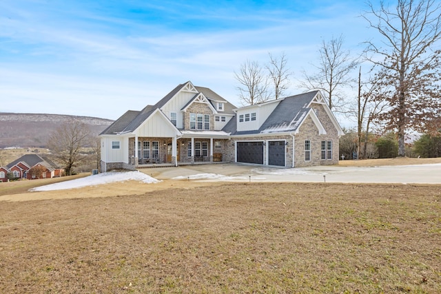 view of front facade featuring a garage, a front lawn, and a porch