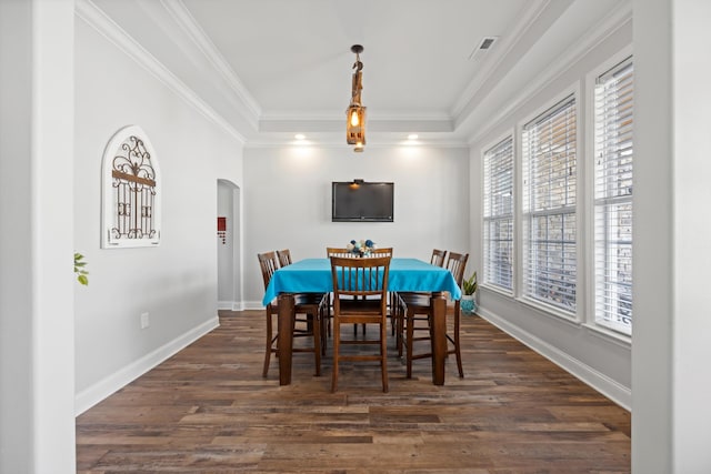 dining room with a healthy amount of sunlight, dark hardwood / wood-style floors, and crown molding