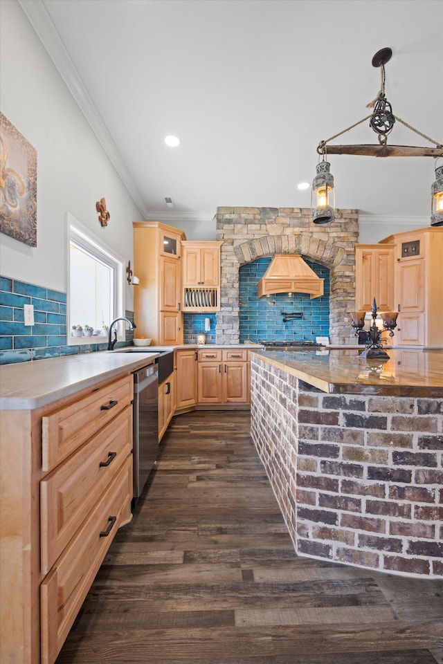 kitchen with tasteful backsplash, light brown cabinetry, dishwasher, and premium range hood