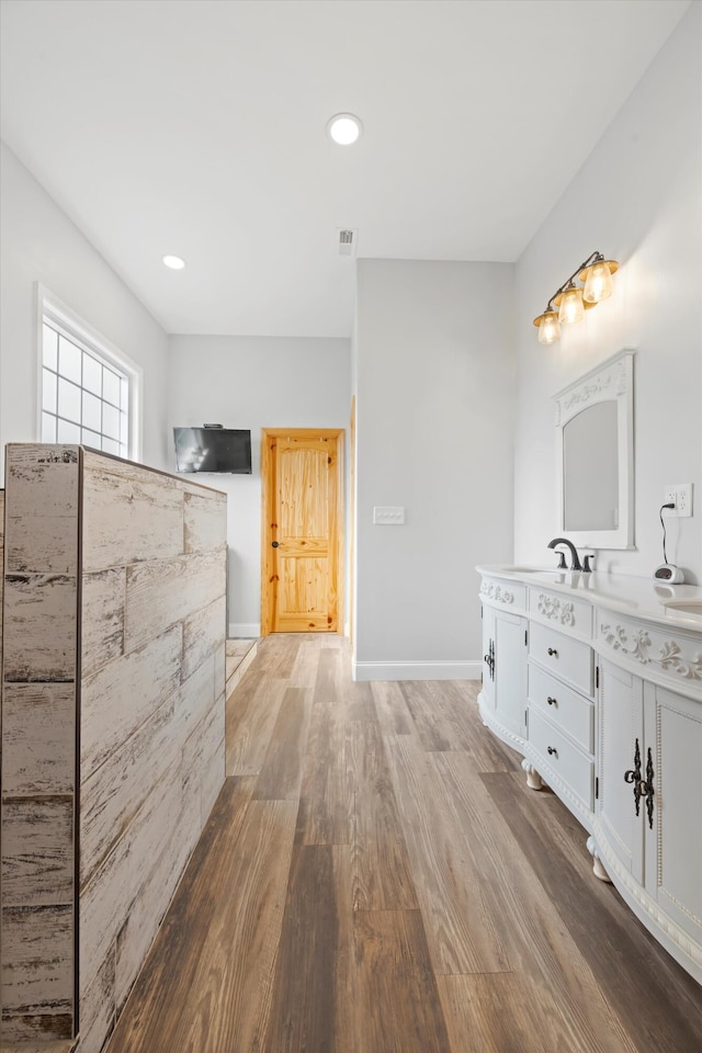 bathroom with vanity and wood-type flooring