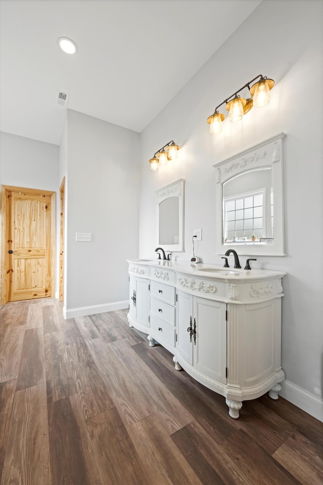 bathroom with hardwood / wood-style flooring and vanity