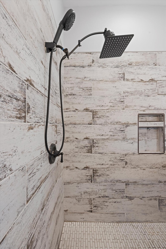 interior details with a tile shower