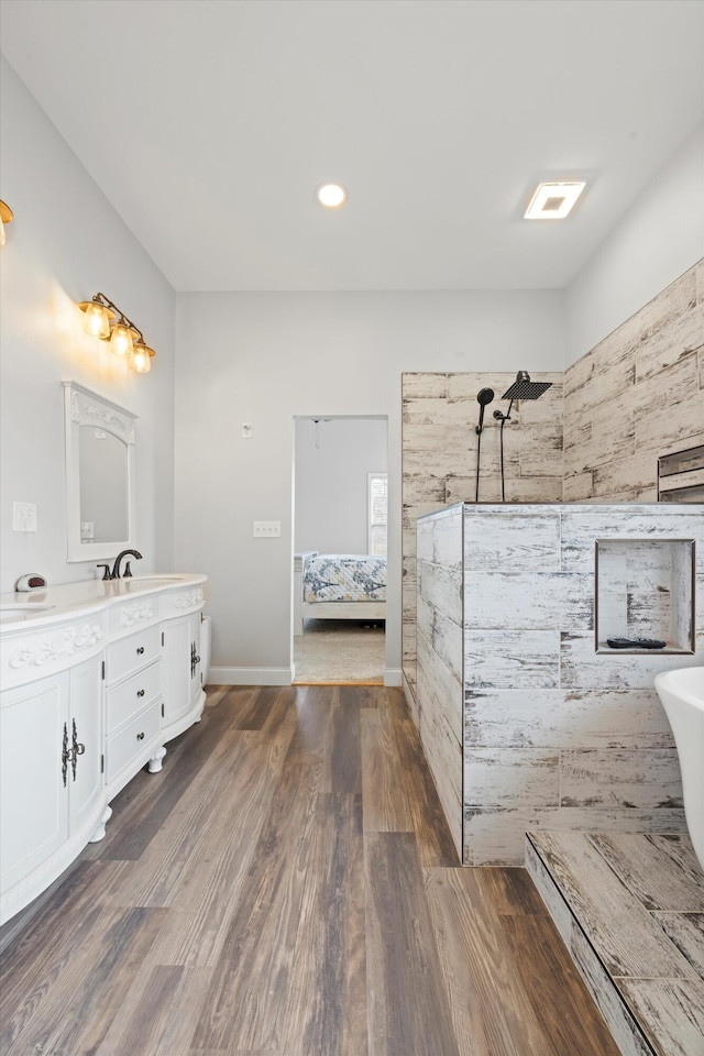 bathroom with vanity, a shower, and hardwood / wood-style flooring