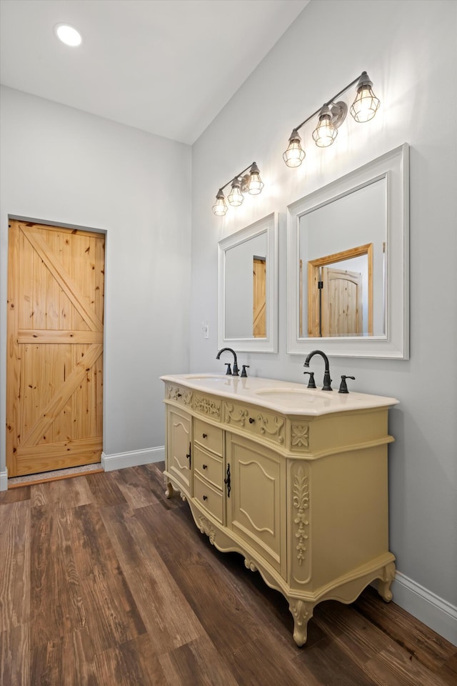 bathroom featuring hardwood / wood-style flooring and vanity