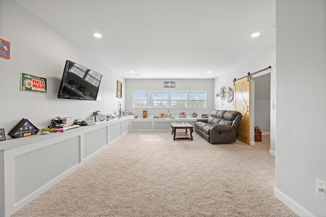 carpeted living room featuring a barn door