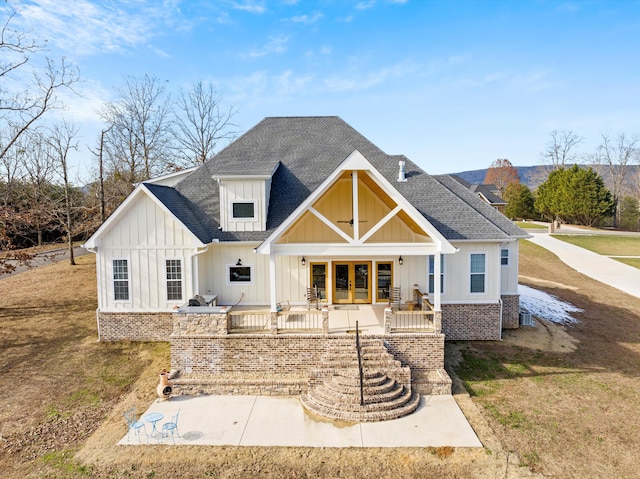 rear view of property featuring french doors and a yard