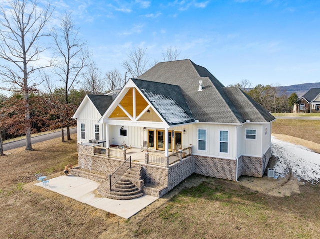 back of house featuring central AC unit, a lawn, and a patio