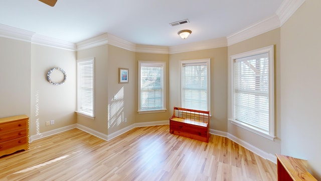 interior space featuring light hardwood / wood-style flooring, plenty of natural light, and ornamental molding