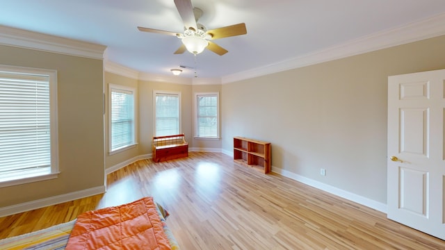 spare room featuring light hardwood / wood-style floors, ceiling fan, and crown molding