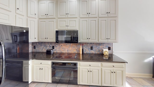 kitchen featuring black appliances, light tile patterned floors, dark stone counters, and tasteful backsplash