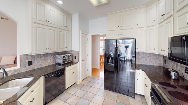 kitchen with backsplash, black appliances, sink, light tile patterned flooring, and white cabinetry