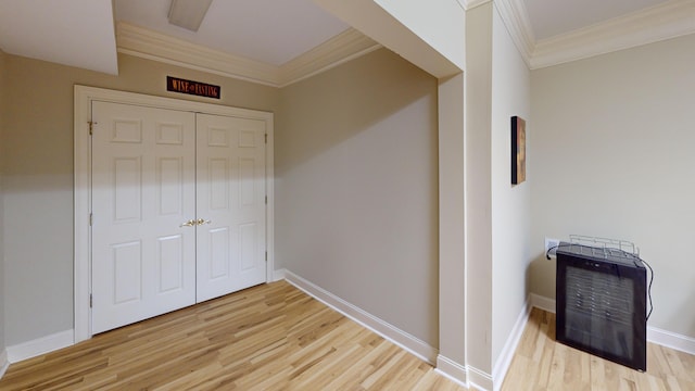 interior space with light wood-type flooring and ornamental molding