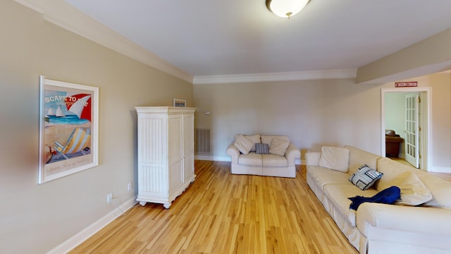 living room featuring light hardwood / wood-style flooring and crown molding